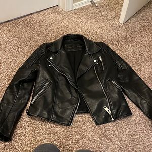 Leather jacket with stitching detail.